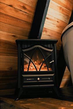Cozy electric fireplace in a wooden interior, showcasing a safe and stylish heating solution.